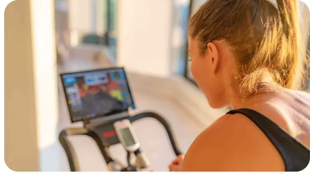 a person riding an exercise bike in front of a computer screen