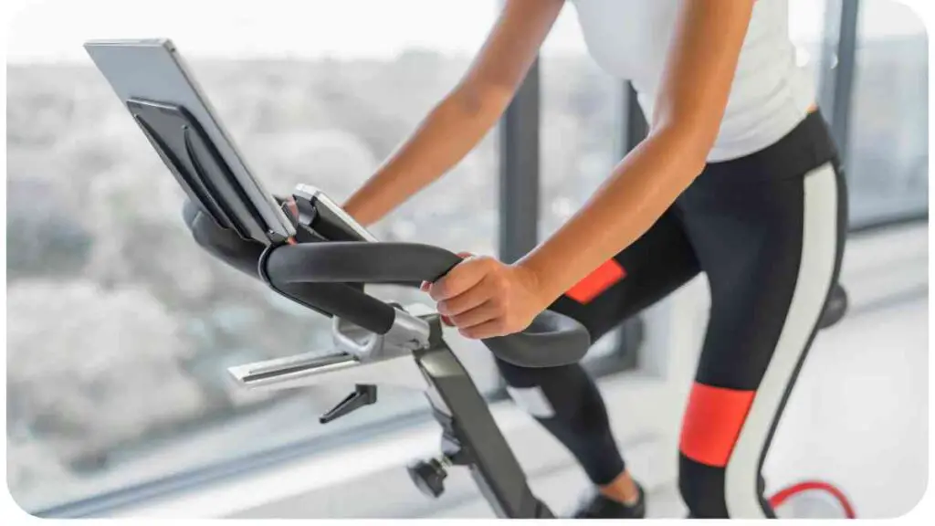 a person riding an exercise bike in front of a window